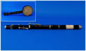 A Vintage Ebony and Ivory Piccolo/Flute. c.1920`s. Length 15.25 inches. Plus a vintage small banjo.