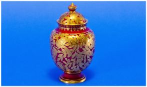Royal Crown Derby Ruby Red And Gold Lidded Vase, with applied gold exotic bird and leaf decoration.