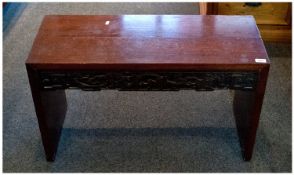 Chinese Rosewood Window Bench with a carved dragon frieze.  Twentieth Century. 20 inches high and