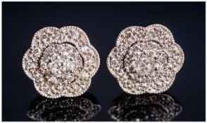 A 9ct Set Pair Of Diamond Cluster Earrings. Flower head design. Est 50 pts. Marked 375.