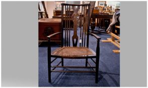 19th Century Oak Strut Back Nursing Chair, with rush seat. 34 inches in height.