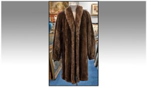 One Beaver Lamb Knee Length Mid Brown Ladies Coat. Cuff sleeves, fully lined (some damage to