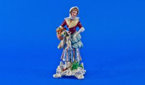 Sitzendorf Figure of a Country Girl carrying a basket of fruit and flowers, a catch net and a hare,