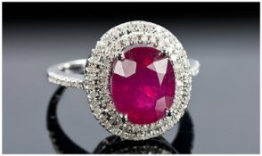 14ct White Gold and Diamond Ring Set with an Oval Cut Ruby, approx 4.75ct. Diamonds approx 0.75ct