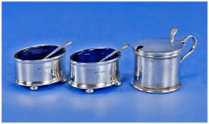 A Silver 3 Piece Cruet Set Of Plain Form and complete with two silver mustard spoons & blue liners.