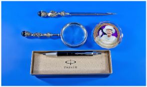 A Desk Set. Comprising first impressions pewter and chrome matching letter opener and magnifying