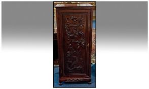 Chinese Rosewood Single Door Pedestal Cabinet with carved dragons to the central panel, terminating