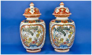Chinese Pair Of Mid 20th Century Decorative Lidded Vases, with character marks to base. Each stands