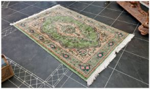 A Burmese Carpet. Lime Green body with beige borders decorated with floral motifs. Size 4 by 6