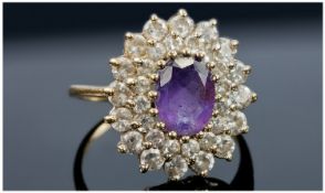 9ct Gold Cluster Ring, Central Amethyst Coloured Stone Surrounded By Two Rows Of Round Cut CZ`s