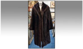 Dark Brown Musquash Coat, slit pockets and fully lined.  Hook and Hoop fastening. Approx size 12-