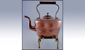 A Copper Kettle, with brass stand. 14 inches high.