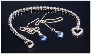 A Silver And CZ Set Bracelet. With silver and sapphire drop earrings.