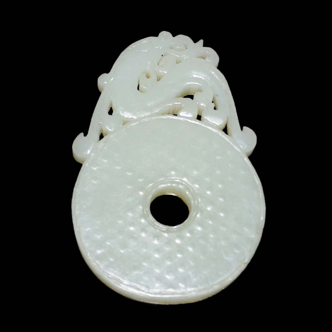 "????????A White Jade Bi Plaque PendantWell carved on both sides in openwork with a dragon atop a bi