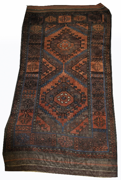 Old Afghan rug, with two medallions on a rust coloured field, tiled boarder, 210cm x 100cm.