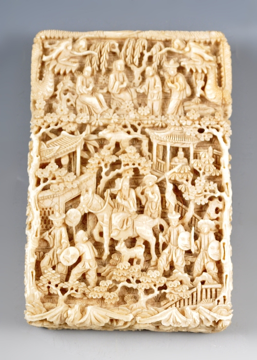 A Cantonese carved ivory visiting card case, 19th Century, decorated in high relief, with (1)