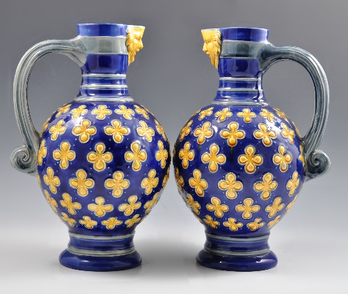 Pair of Minton Majolica jugs, date ciphers probably 1872, blue ground with quatrefoil leaves and