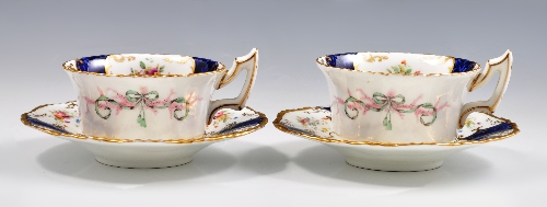 Three Coalport bone china cabinet cups and saucers, floral reserves on a patterned royal blue ground