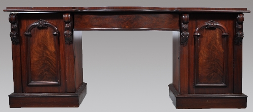 An early Victorian mahogany twin pedestal sideboard, serpentine shaped centre drawer, flanked by