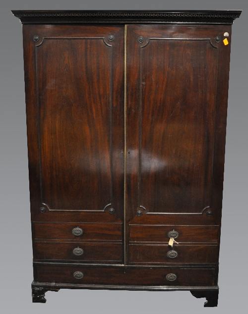 A Victorian mahogany wardrobe, dentil and cavetto cornice, two doors incorporating panels and