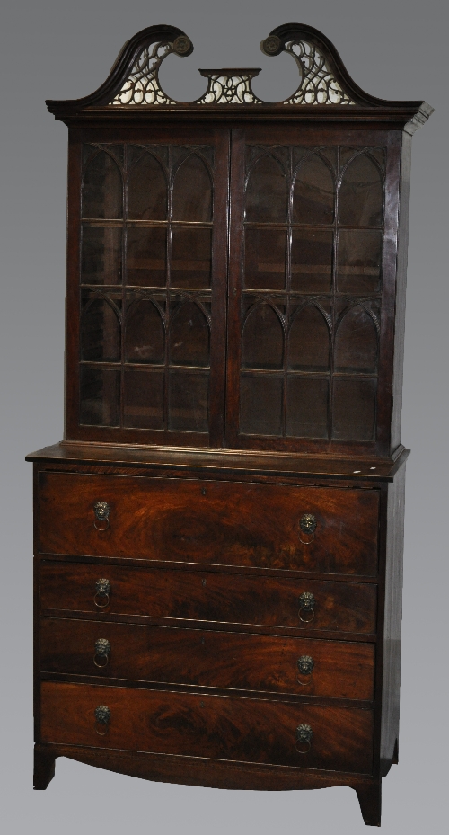 A George III mahogany bookcase secretaire, broken swan-neck pediment, with fretwork, two glazed