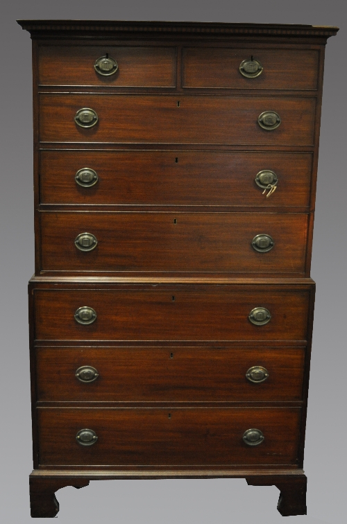 A George III mahogany chest on chest, inlaid dentil panel to the cavetto moulded cornice, with