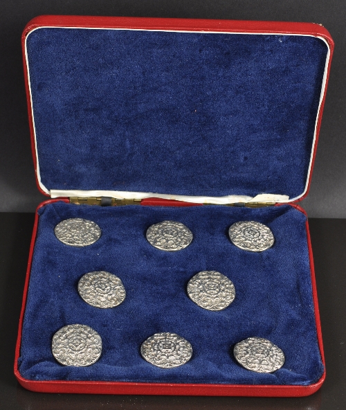 A set of eight Victorian cast silver circular buttons, by William Francis Garrud London 1890, cast