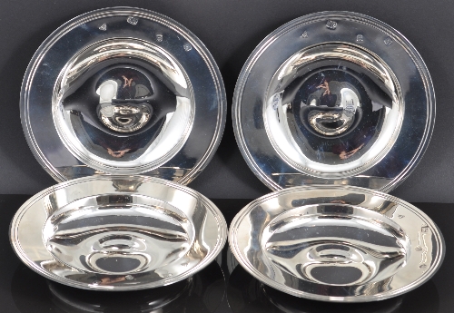 A set of four circular silver armada dishes, by Garrard & Co Limited, London 1984, plain moulded