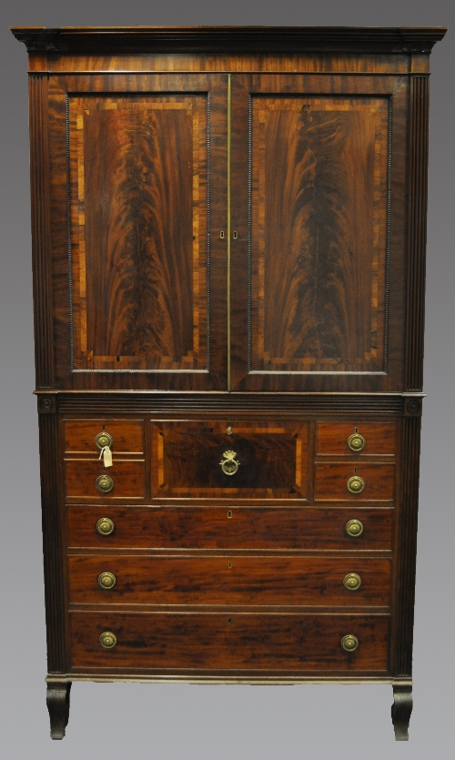 A William IV mahogany press secretaire, moulded cornice, plain frieze, two panelled doors to the