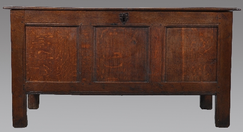 A joined oak coffer, early 18th Century, single plank top, the front fascia with three panels, stile