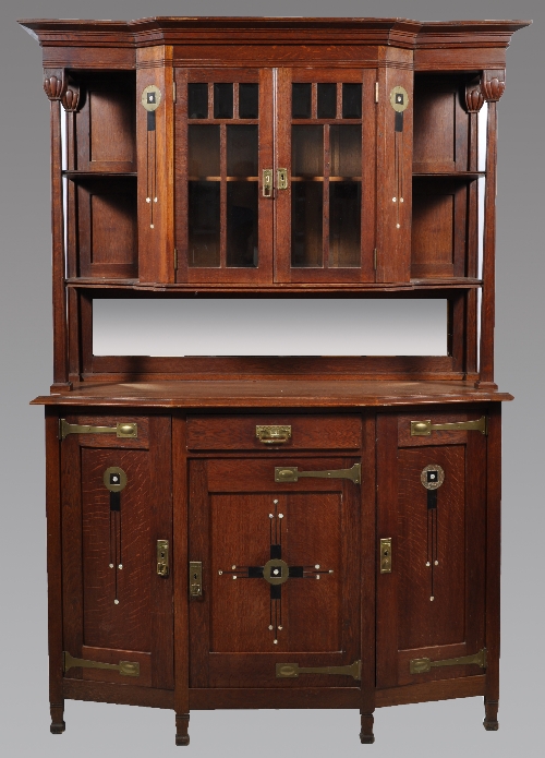 A Secessionist/ Jugendstil style oak sideboard, with raised central glazed cupboard flanked by