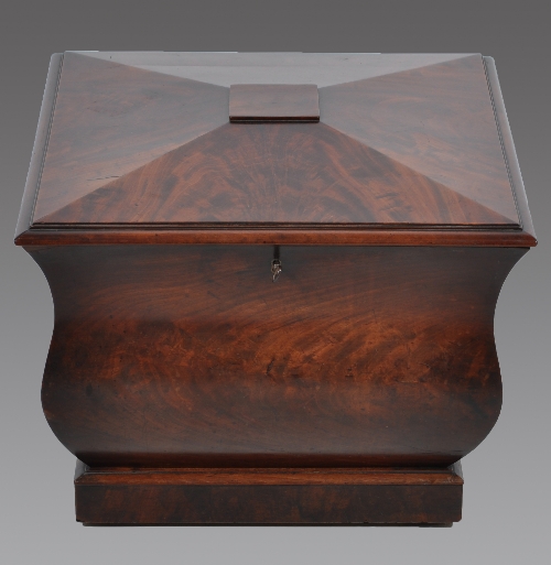 A William IV mahogany sarcophagus shaped wine cooler, square section, bombe shaped form, plain