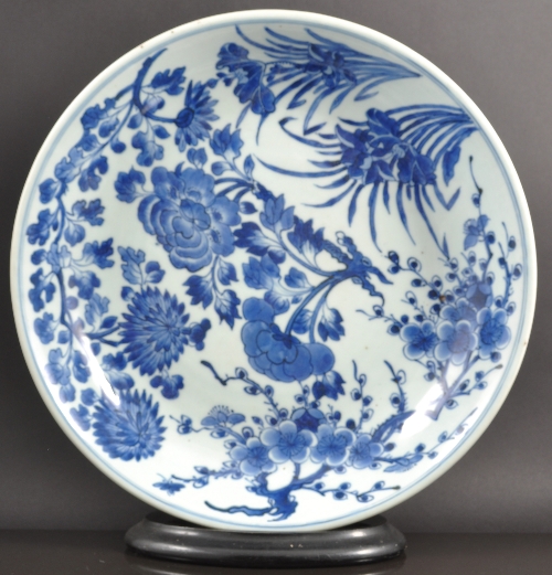 A Chinese porcelain blue and white shallow bowl, perhaps 19th Century, painted with flowering