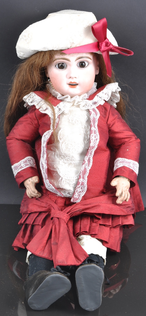 A Jumeau Bebe bisque head doll, with original wig and pate, brown paperweight eyes and delicate open