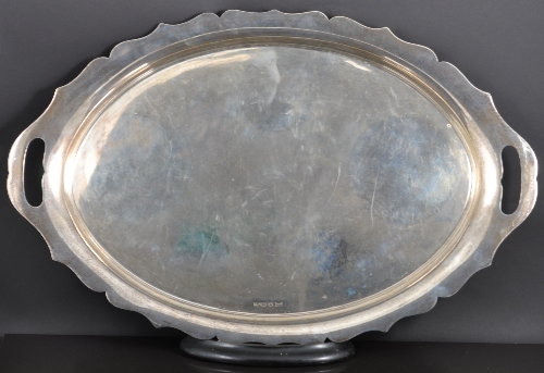 An Oval silver tea tray by Walker Hall, Sheffield 1942, serpentine outlines, twin handles, 66oz,