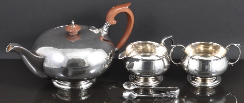 A circular silver tea pot, by Walker & Hall, Sheffield 1932, compressed form, Bakelite handle and