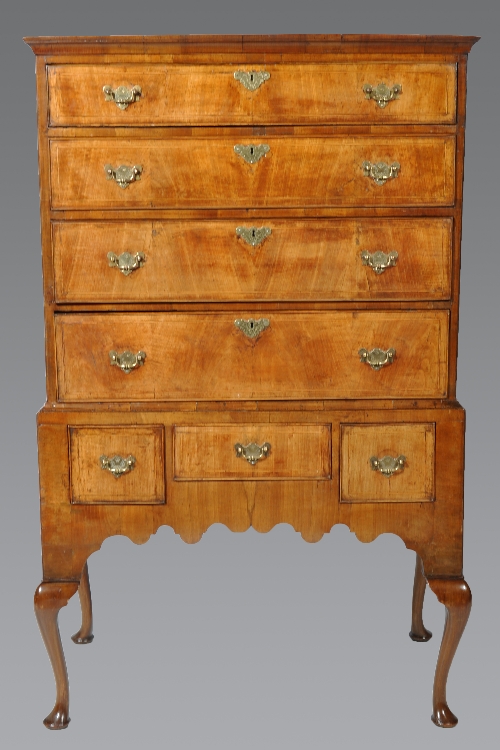 A George II walnut chest on stand, with adaptions, cavetto moulded cornice, the upper section with