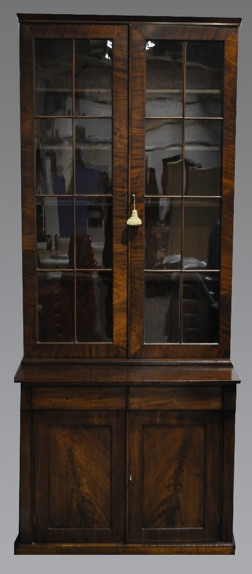 A Victorian mahogany bookcase cabinet, adapted, narrow cornice, two eight panelled glazed doors to