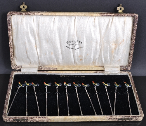 A set of twelve sterling silver enamel cocktail sticks, with Cockerill terminals in a box marked