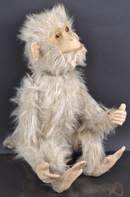 A Schuco "Yes-No" monkey, having long blonde mohair with felt hands, feet, face and ears, working