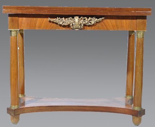 A French Empire style mahogany card table, rectangular fold-over top, enclosing a tooled leather