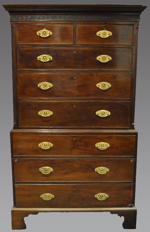 A George III mahogany chest on chest, dentil and cavetto cornice, blind fretwork frieze, the upper
