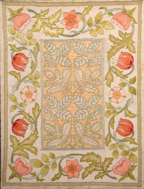 An Arts and Crafts needlework panel, circa 1900, mounted on a stretcher, the central field with