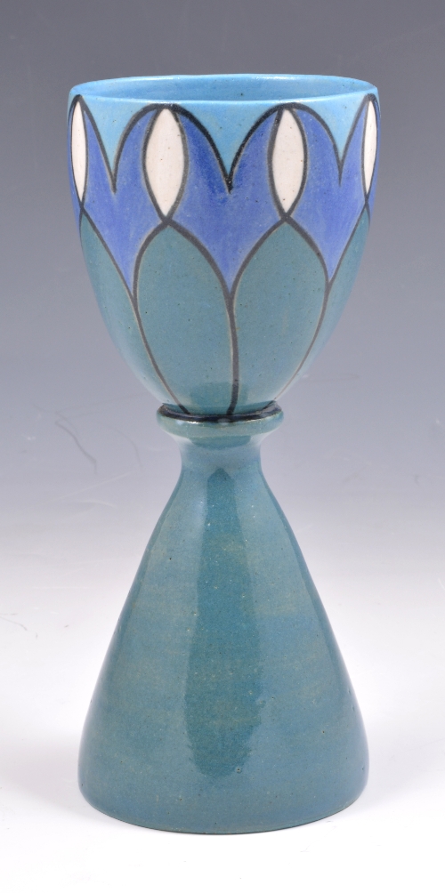 A British art pottery goblet, decorated to the exterior with stylised banding in tones of blue,