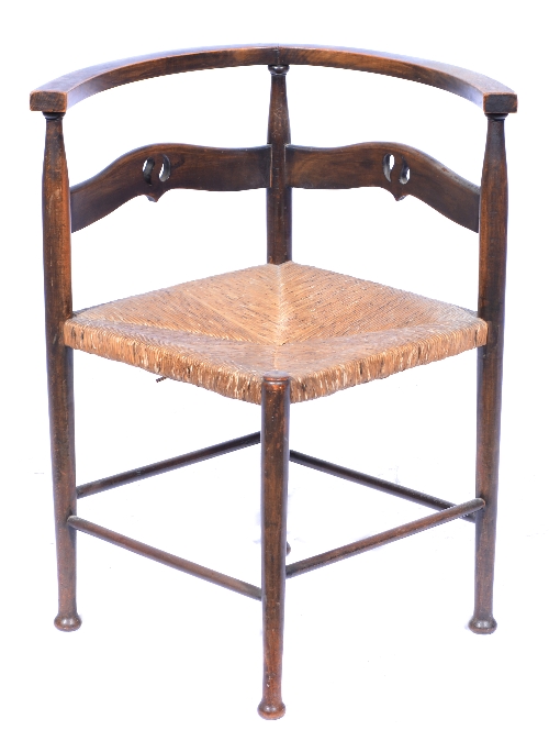 An Arts and Crafts corner chair, circa 1900, in the manner of William Birch, stained beech with rush