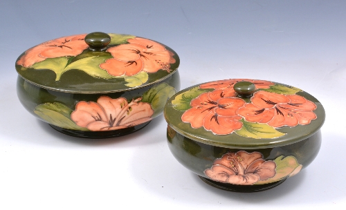 Two Walter Moorcroft 'Hibiscus' design box and covers, circa 1970, the circular boxes decorated with