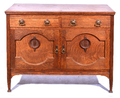 A British Arts and Crafts oak sideboard, circa 1910, the rectangular top above two frieze drawers,