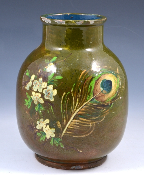 A Burmantofts Faience pottery vase, circa 1880, decorated with a single peacock feather and stylised