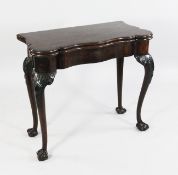 A George III mahogany serpentine folding tea table, with expanding concertina action, on shell and