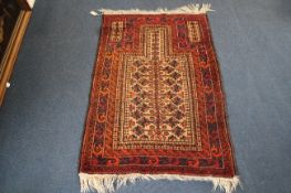 A Turkish prayer rug, the central mihrab with geometric foliate motifs, on a red ground, with